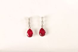 Platinum pear-cut ruby and diamond drop studs with rubberised butterflies. Rubies 2.00ct. Diamonds