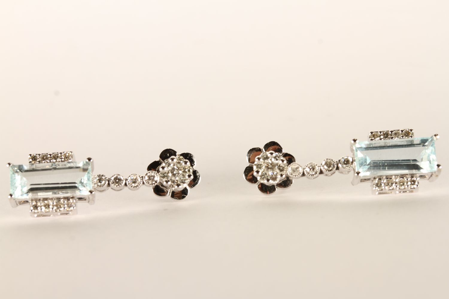 Pair of Aquamarine and Diamond Earrings, each set with a baguette cut aquamarine, 4 claw set,