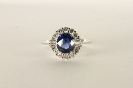 18ct white gold sapphire and diamond cluster ring. Oval-cut sapphire 1.75ct. RBC diamonds 0.40ct.