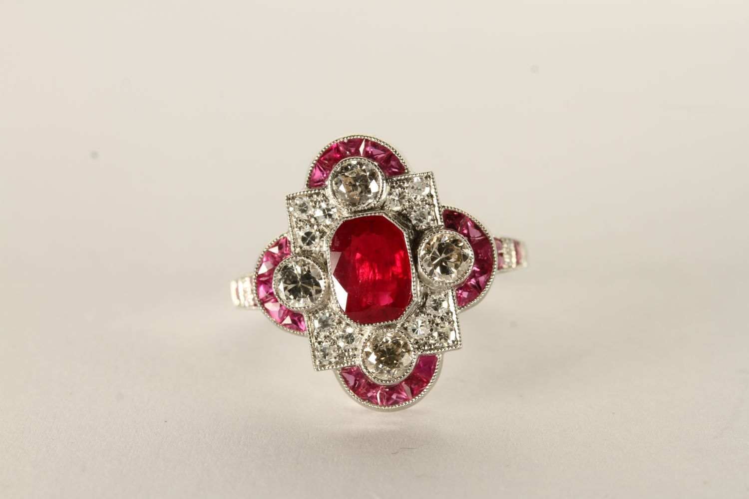 Edwardian-style platinum ruby and diamond dress ring. Central ruby 1.65ct, approx. Diamonds, 1.20
