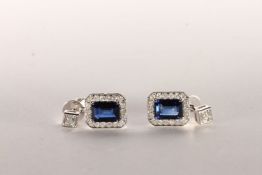 Pair of Sapphire and Diamond Earrings, set with 2 emerald cut dark vivid blue sapphires to the