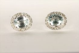 Pair of Aquamarine and Diamond Stud Earrings, set with a total of 2 oval cut light blue