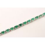 Emerald and Diamond Bracelet, set with 22 oval cut medium green emeralds totalling 7.05ct, claw set,