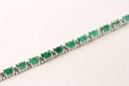 Emerald and Diamond Bracelet, set with 22 oval cut medium green emeralds totalling 7.05ct, claw set,