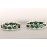 Pair of Emerald and Diamond Hoop Earrings, set with a total of 18 oval cut medium to dark green