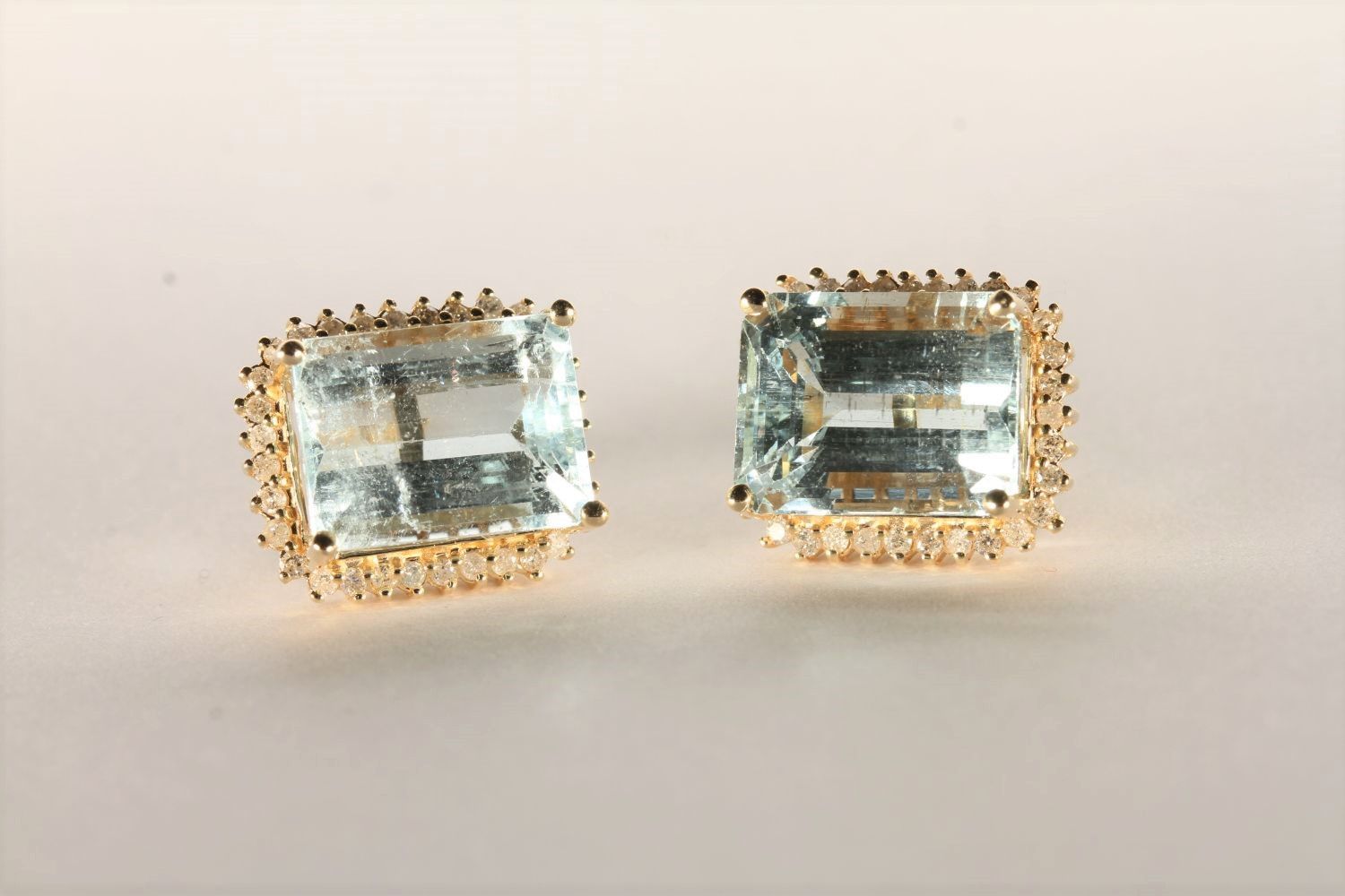 Pair of Aquamarine and Diamond Stud Earrings, set with 2 emerald cut light blue aquamarines