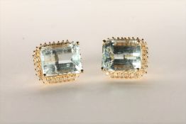 Pair of Aquamarine and Diamond Stud Earrings, set with 2 emerald cut light blue aquamarines