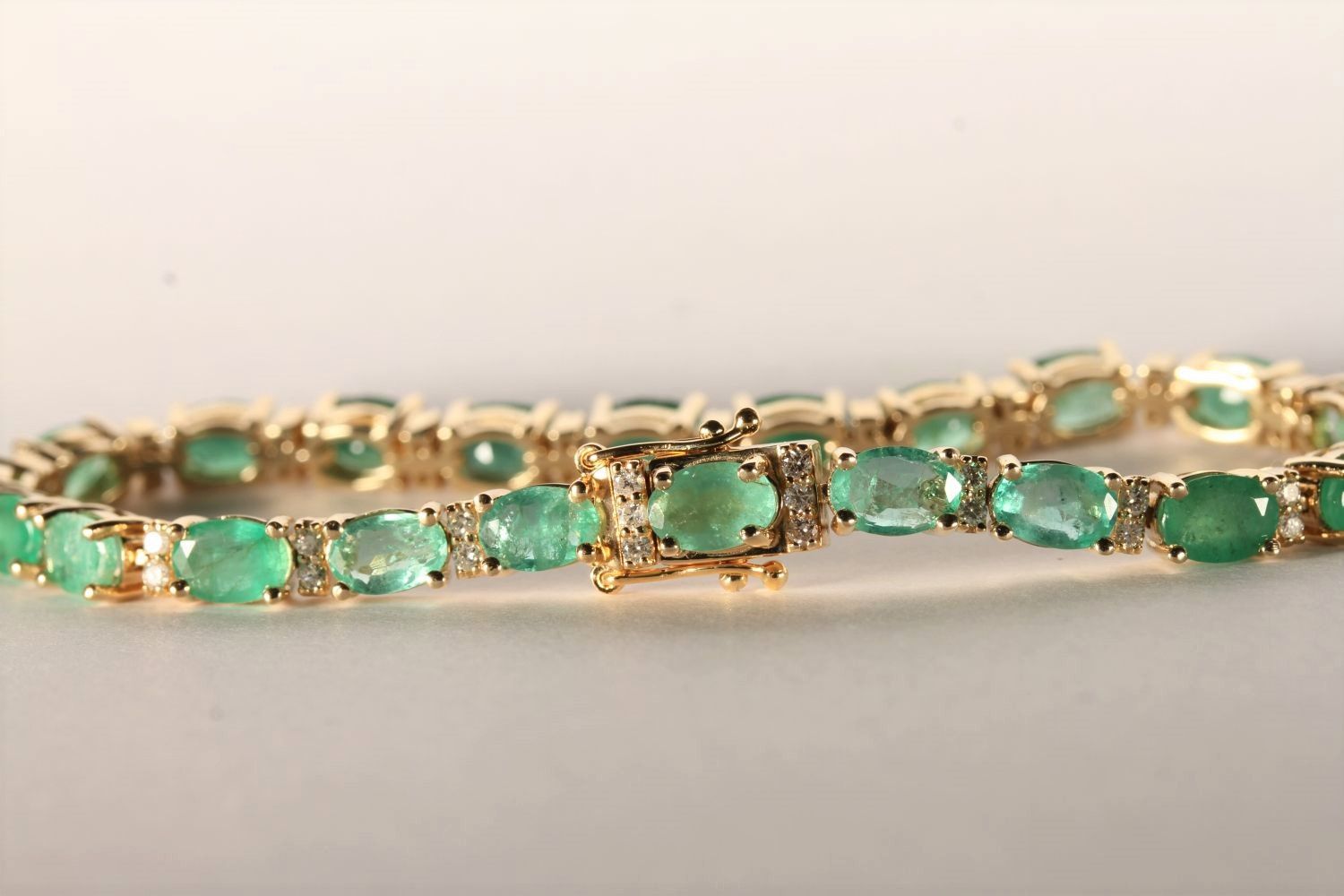 Emerald and Diamond Bracelet, set with 22 oval cut medium green emeralds totalling 7.02ct, claw set, - Image 2 of 3