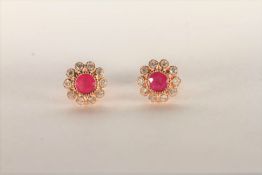 Pair of Ruby and Diamond Flower Stud Earrings, set with a a total of 2 pinkish red rubies