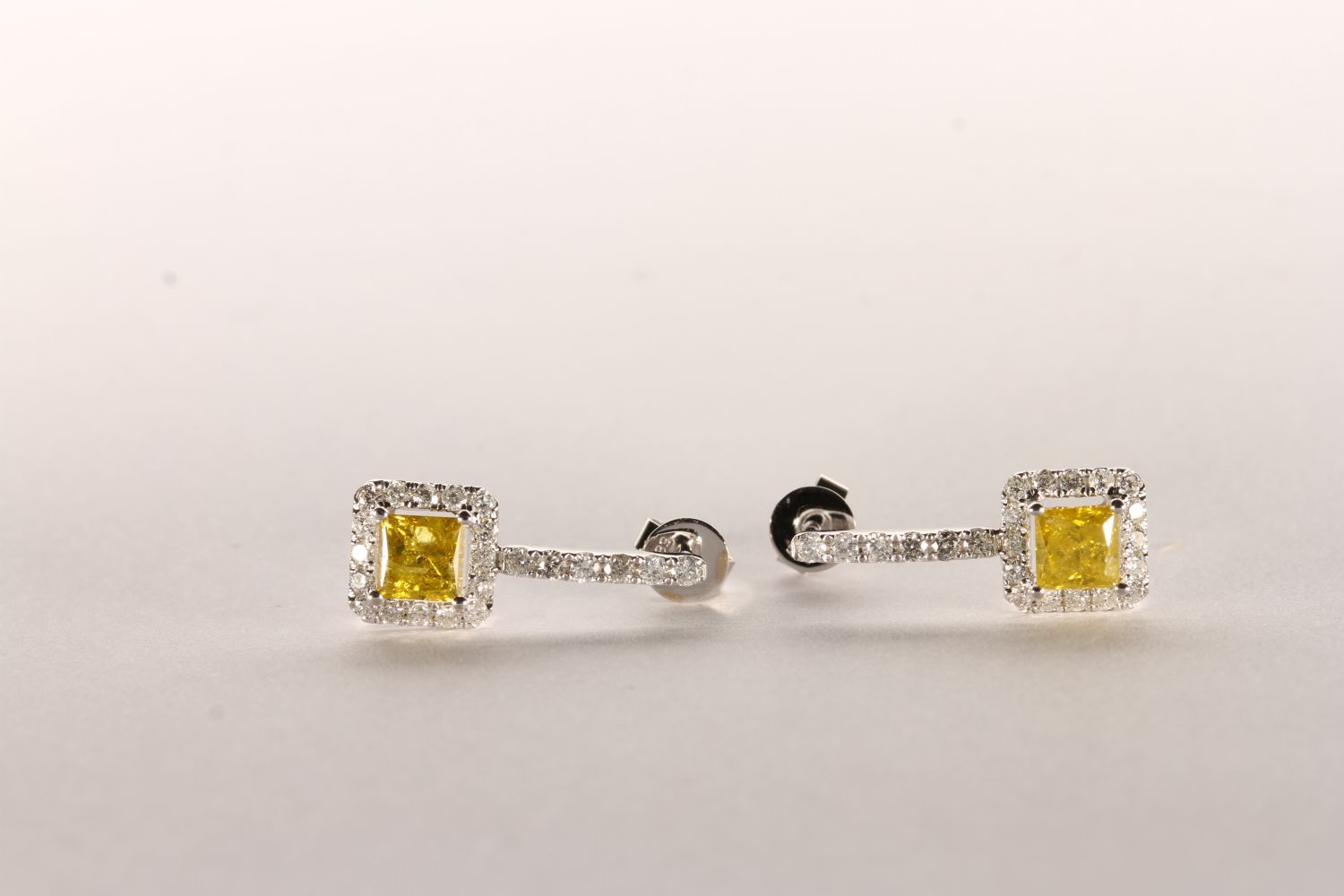 Pair of Diamond Drop Earrings set with 2 princess cut vivid yellow diamonds to the centre