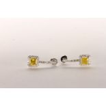 Pair of Diamond Drop Earrings set with 2 princess cut vivid yellow diamonds to the centre