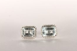 Pair of Aquamarine and Diamond Stud Earrings, set with 2 emerald cut light blue natural