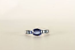 Sapphire and diamond ring, mounted in white metal stamped 18K, central oval sapphire claw set,