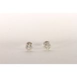 Pair of Diamond Stud Earrings, set with 2 round brilliant cut diamonds to the centre totalling 0.