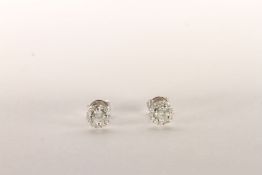 Pair of Diamond Stud Earrings, set with 2 round brilliant cut diamonds to the centre totalling 0.