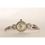 LADIES VINTAGE STYLE MOVADO WRISTWATCH, circular silver dial with hour markers and arabic numbers,