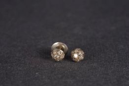 Pair of diamond stud earrings, each set with seven round cut diamonds, estimated total diamond weigh