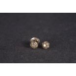 Pair of diamond stud earrings, each set with seven round cut diamonds, estimated total diamond weigh