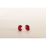 Pair of Ruby Stud Earrings, each set with an oval cut treated ruby, 4 claw set, stamped sterling