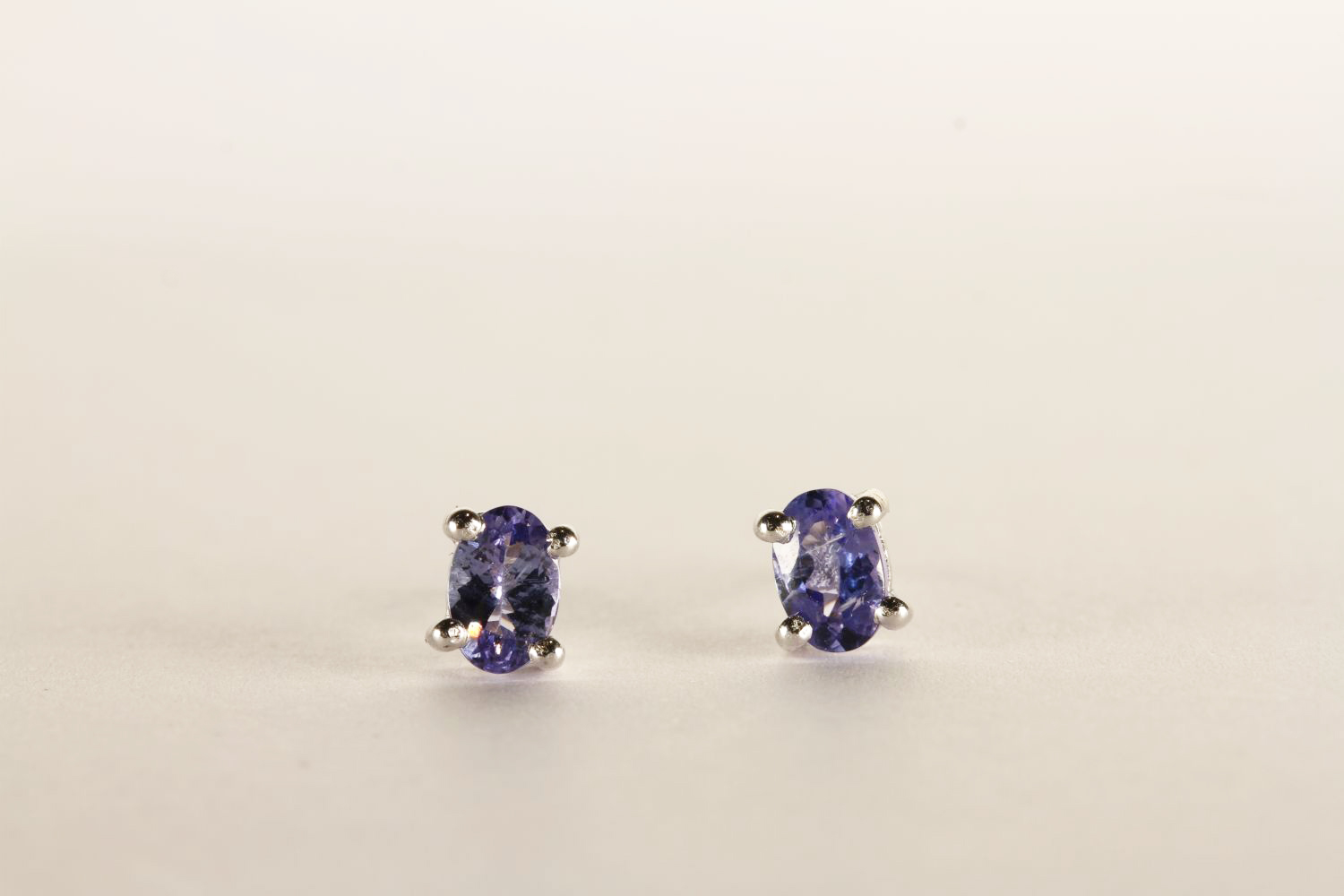 Pair of Tanzanite Stud Earrings, each set with an oval cut tanzanite, 4 claw set, stamped sterling