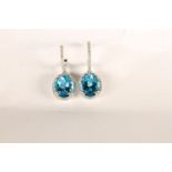 Pair of Blue Topaz and Diamond Drop Earrings, each set with an oval cut blue topaz, claw set,