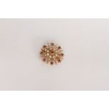 Ruby and pearl set star brooch, ruby set centre, pearl set spray, stamped and tested as 9ct, 5.8g