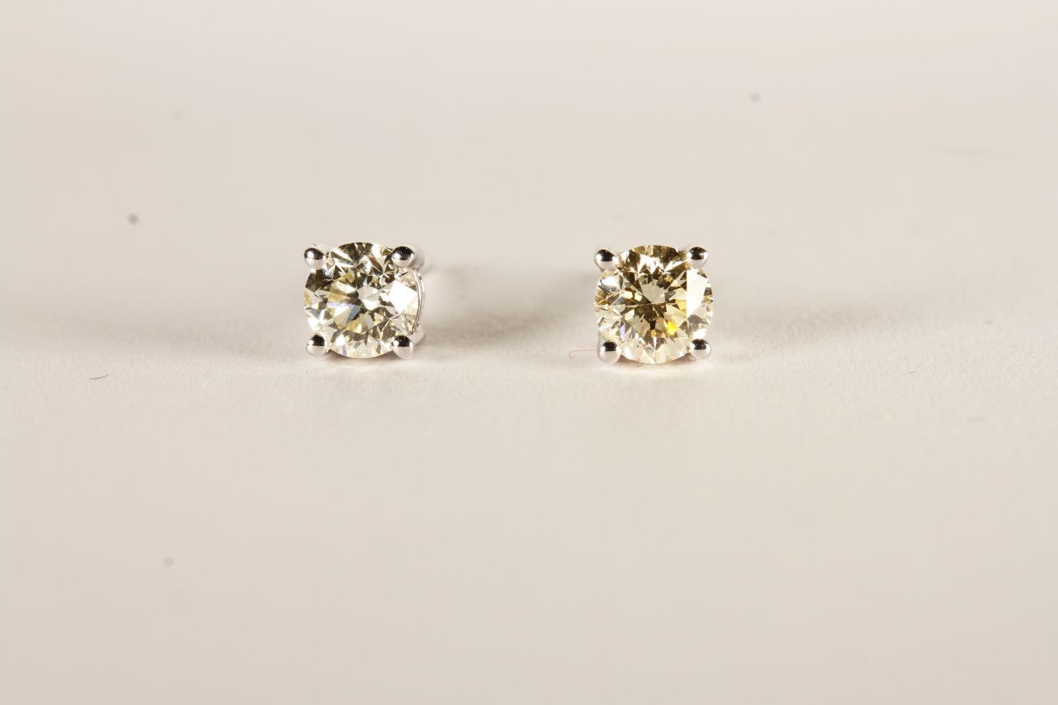 Pair of Diamond Solitaire Stud Earrings, each set with a round brilliant cut diamond, 4 claw set,