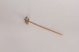 Diamond stick pin, set with a diamond floral detail, estimated diamond weight 0.07ct, in yellow