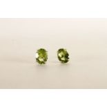 Pair of Peridot Stud Earrings, each set with an oval cut peridot, 4 claw set, stamped sterling