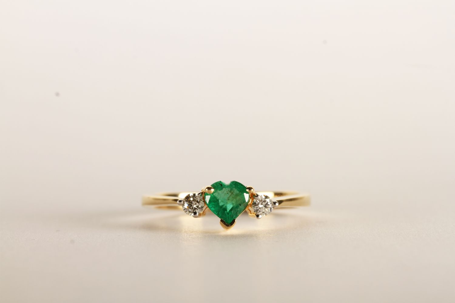 Diamond and Emerald Heart Ring, set with a heart shaped emerald approximately 0.25ct and 2 round