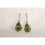 Pair of Peridot and Diamond Drop Earrings, set in a flower design, fish hook backs, approximate drop