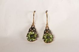 Pair of Peridot and Diamond Drop Earrings, set in a flower design, fish hook backs, approximate drop