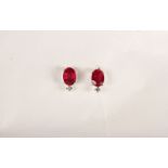 Pair of Ruby and Diamond Stud Earrings, each set with an oval cut ruby, 4 claw set, total