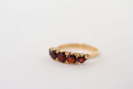 18ct Garnet five stone carved half hoop ring, graduated garnet stones, mounted in hallmarked 18ct,