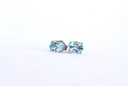 Pair of Blue Topaz Stud Earrings, each set with an oval cut blue topaz,