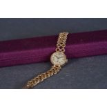 LADIES TUDOR 9CT GOLD COCKTAIL WATCH W/ ROLEX BRACELET, circular patina dial with hour markers and