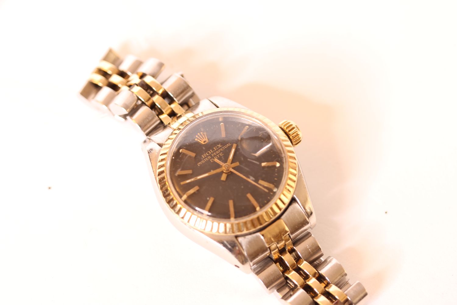 LADIES TWO TONE ROLEX DATE WRISWATCH, circular black dial with gold hands and gold hour markers,