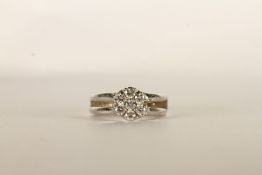 Diamond Flower Ring, set with 7 round brilliant cut diamonds, claw set, finger size F. please note