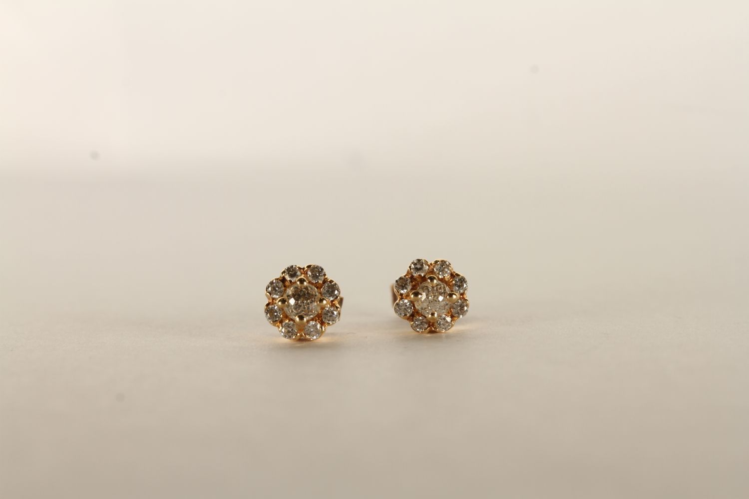 Pair of Diamond Flower Earrings, set with round brilliant cut diamonds in a flower shape, stamped