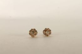 Pair of Diamond Flower Earrings, set with round brilliant cut diamonds in a flower shape, stamped