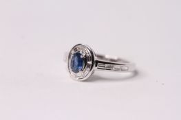 Oval Cut Sapphire and Baguette Cut Diamond Cluster Ring, diamonds are channel set in a halo around
