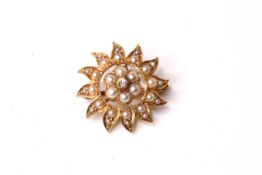 Edwardian Diamond and Pearl set star brooch, 20mm diameter, in yellow gold stamped and tested as