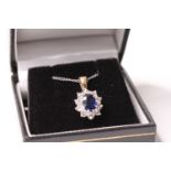Oval-cut sapphire and round brilliant cut diamond cluster pendant, 18ct yellow and white gold, on