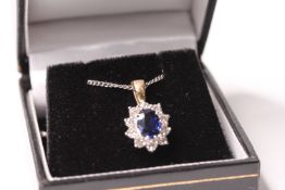 Oval-cut sapphire and round brilliant cut diamond cluster pendant, 18ct yellow and white gold, on