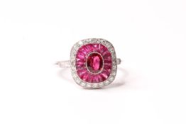 Platinum ring set with central ruby, a halo of calibre-cut rubies and a halo of diamonds