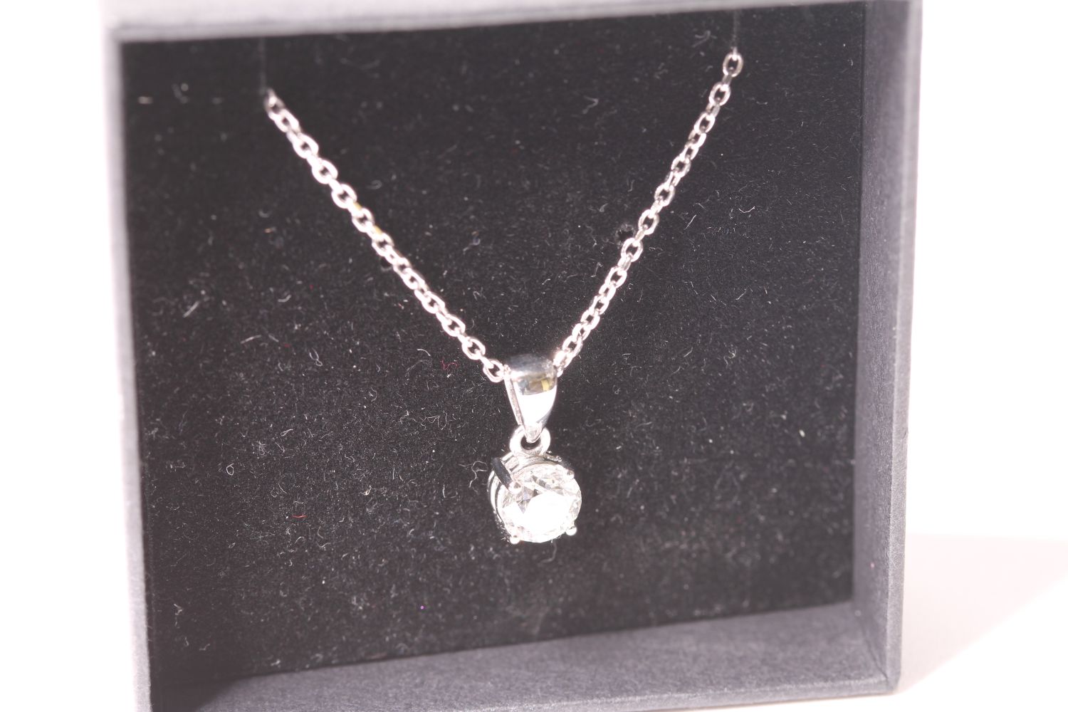 18ct white gold four claw diamond solitaire pendant and chain, boxed. RBC diamond 0.58ct