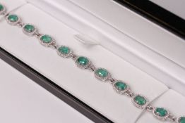 18ct white gold emerald and diamond line bracelet, oval-cut emeralds total approximately 7.12ct,