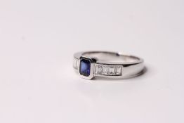 18ct white gold sapphire and channel-set diamond ring, central emerald-cut sapphire