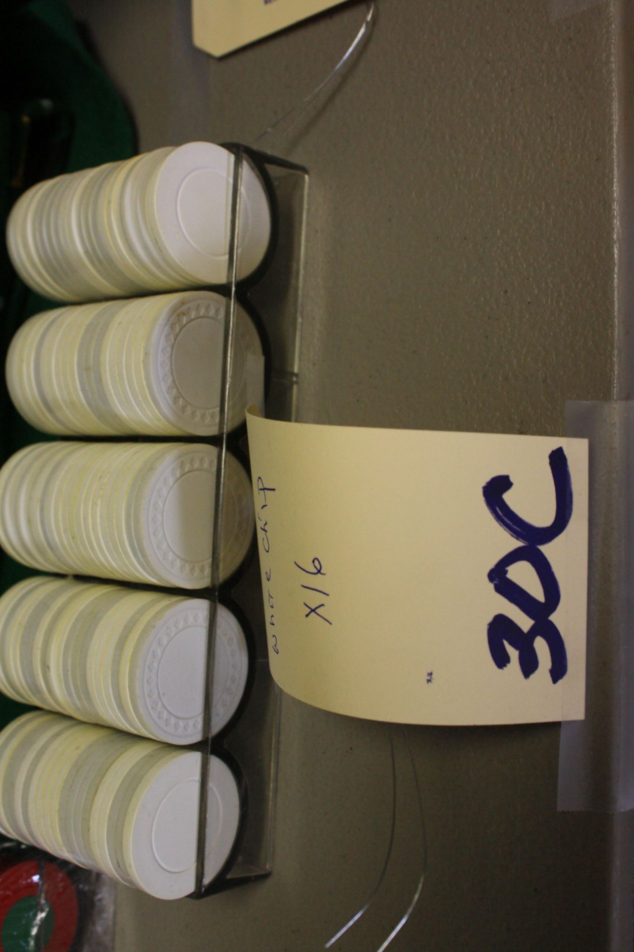 Poker chips in rack, white/off white