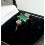 18ct gold Emerald and diamond ring central emerald measures approx 7.5mm by mm set with diamond eith